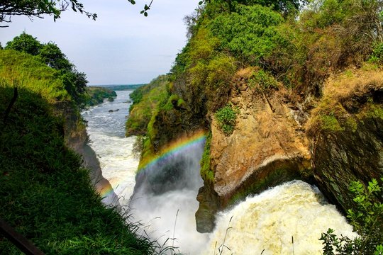 A rainbow hanging in the mist over Murchison Falls waterfall, Uganda