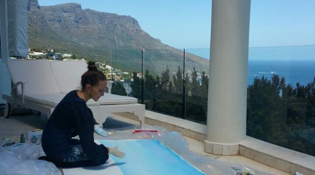 Jeannine Platz hand painting her Suite View of Camps Bay at Atlantique Villa Camps Bay
