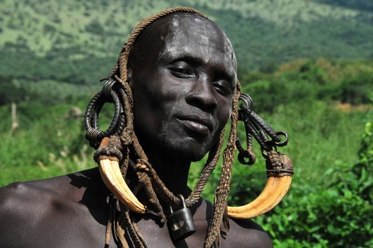 Mursi Man from Omo Valley Regions-Women clay lip platted people.