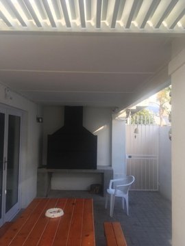 Outdoor covered braai area with seating area