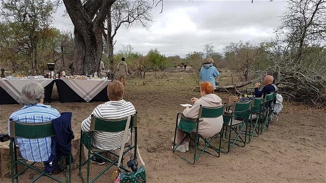 Bush breakfast at Nkorho, with guides keeping an eye on an approaching buffalo herd. 