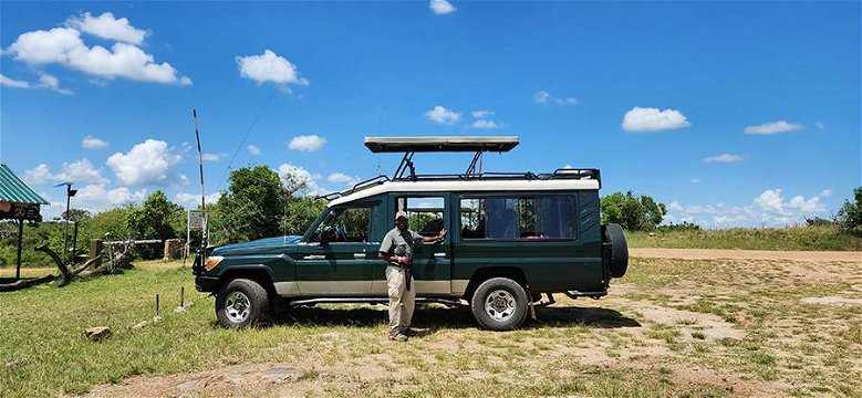 Our fantastic local guide, Mamai Johns, and safari vehicle