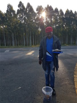 Local resident selling sustainably sourced honey next to the N2 on the way to Makakatana Bay Lodge, KZN