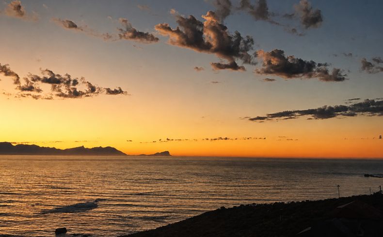 Golden light and clouds above False Bay, viewed from Simon's Town
