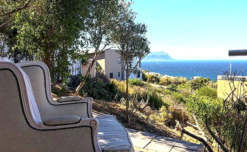 Orca suite outdoor seating and balcony overlooking False Bay at Aqua Terra in Simon's Town