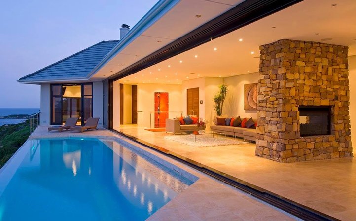 Aqua Terra's illuminated lounge and infinity pool at twilight