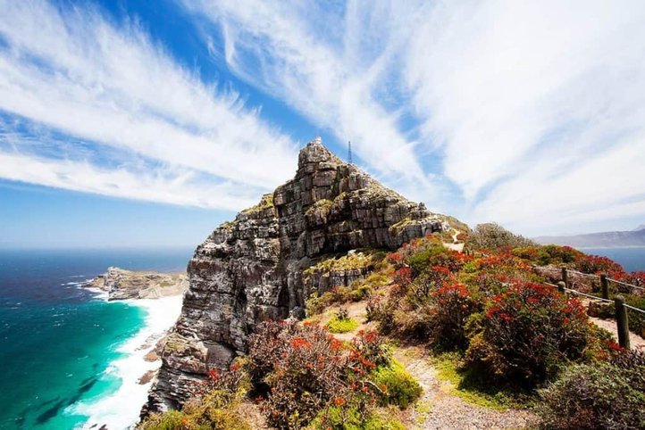 Cape Point cliffs and coastal vegetation beneath streaked clouds