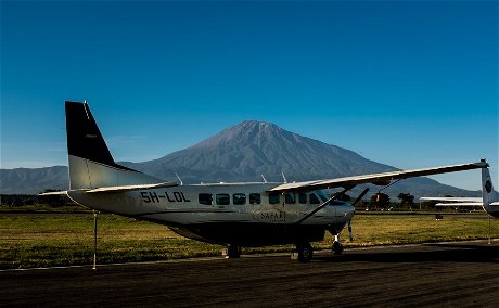 A Safari Air Link Cessna Grand Caravan at Kilimanjaro International Airport, with Mount Meru in the background. 