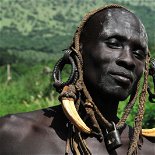 Mursi Man from Omo Valley Regions-Women clay lip platted people.