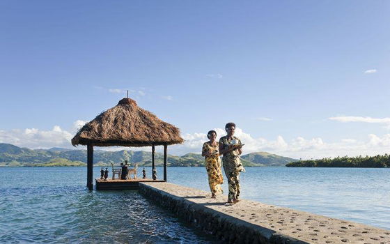 Floating pontoon bed over turquoise waters, creating a romantic escape