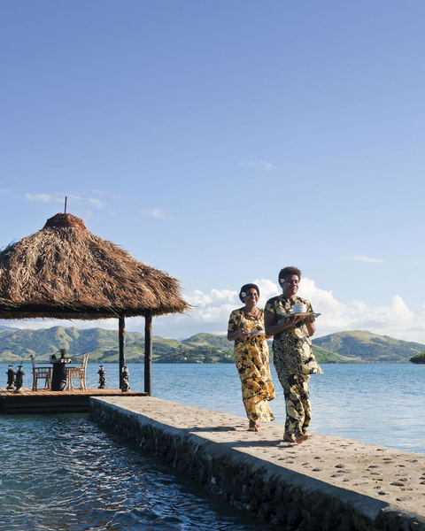 Floating pontoon bed over turquoise waters, creating a romantic escape