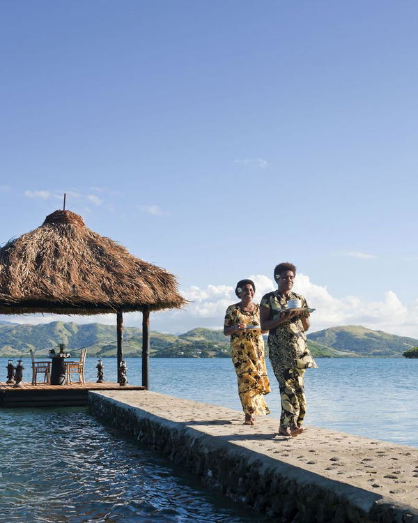 Floating pontoon bed over turquoise waters, creating a romantic escape