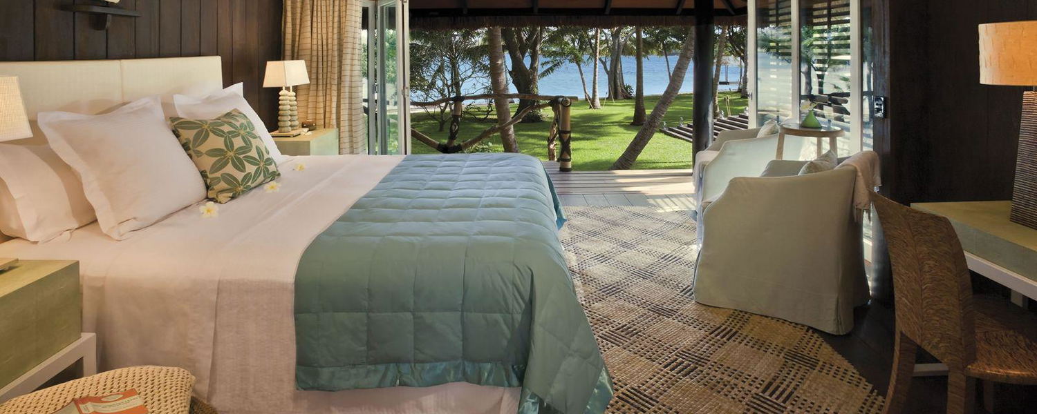Interior of a guest bure surrounded by lush tropical gardens at Dolphin Island