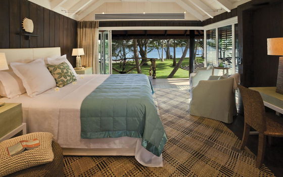 Interior of a guest bure surrounded by lush tropical gardens at Dolphin Island