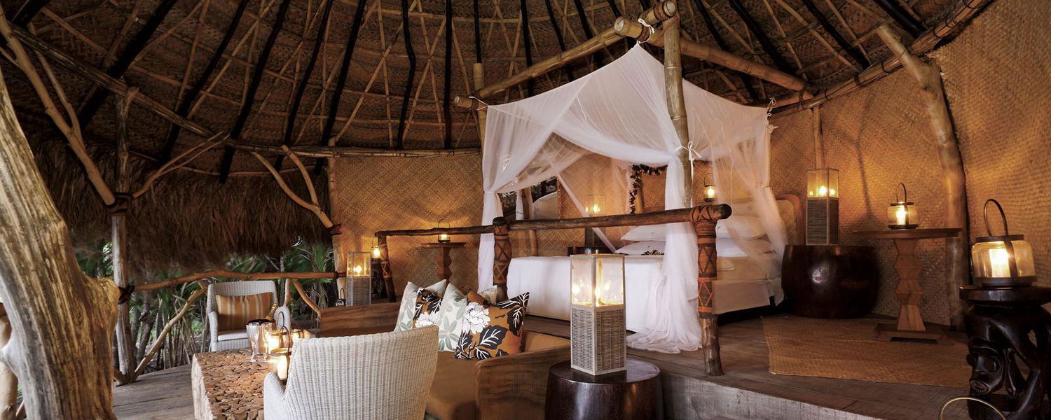 Hilltop sleep-out with a canopy bed overlooking tropical ocean at Dolphin Island