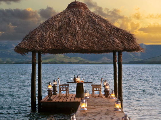Floating pontoon bed over turquoise waters, creating a romantic escape