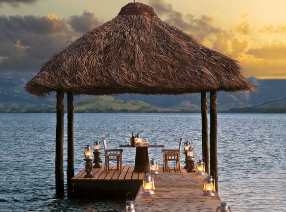 Floating pontoon bed over turquoise waters, creating a romantic escape