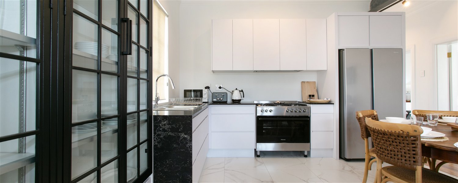 Open plan kitchen with gas hob, fridge freezer, double basin at La Maison On Main Self-Catering Villa, Paarl