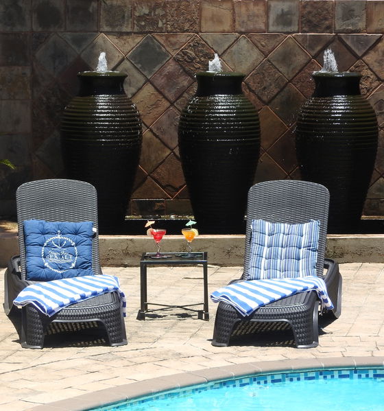 SUNLOUNGERS AT THE POOLSIDE