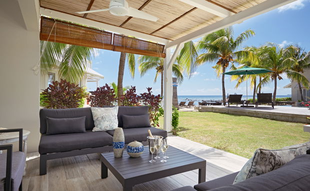 Patio with seating area, sea and pool view 