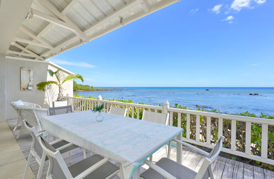 Private balcony with dining area overlooking the ocean