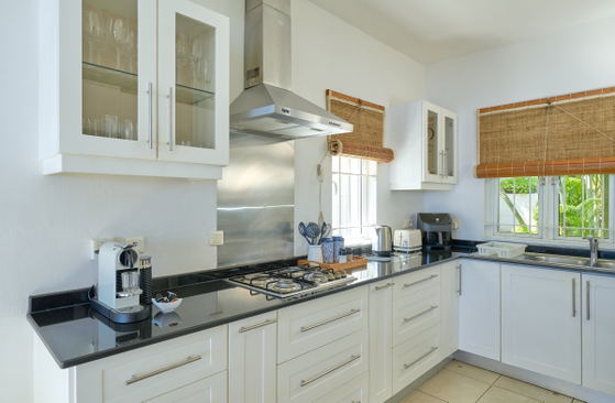 Spacious villa kitchen with breakfast island and modern finishes