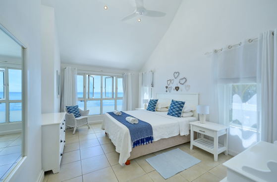 Bedroom with large windows and ocean views