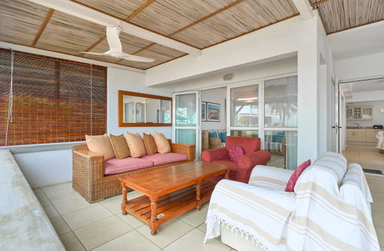 Outdoor dining set on the patio with ocean views and access to the villa