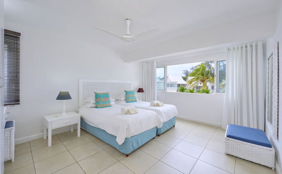Airy bedroom with queen bed and white linen