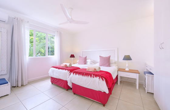 Modern bedroom with bed throw and large windows