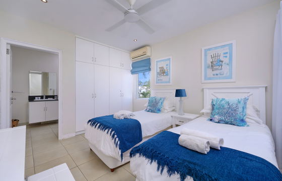 Cozy bedroom with twin bed and sea-themed art