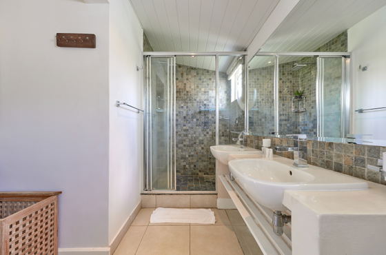 Modern bathroom with glass shower and stone countertop