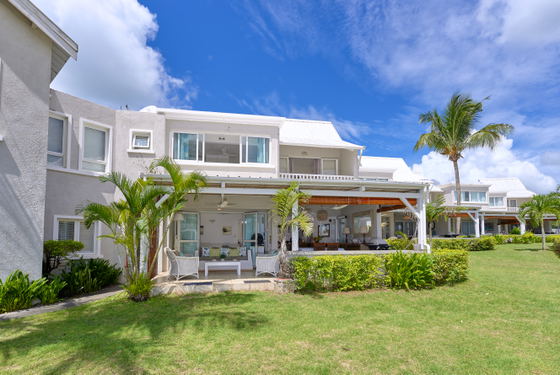 Ocean-view villa exterior with manicured lawn
