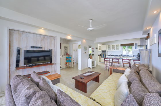 Villa lounge area with large sectional sofa and entertainment setup