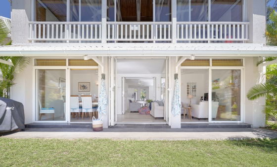 Exterior view of ground floor tropical villa with lush gardens"