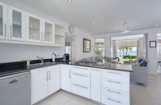 Compact kitchen with dark cabinetry and modern appliances