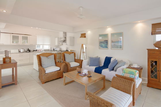 Modern living and dining space with neutral tones and art pieces