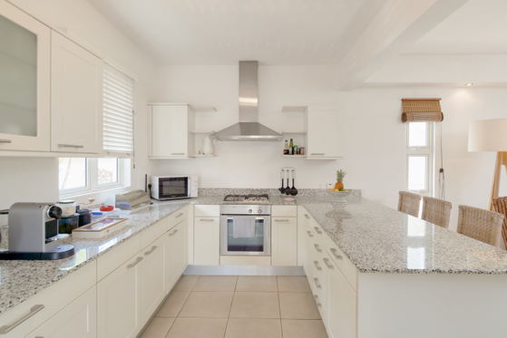 Modern white kitchen, fully equipped 