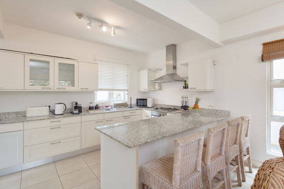 Breakfast table with stove and all kitchen appliance 