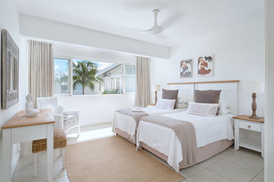 Modern bedroom with neutral colours and big windows