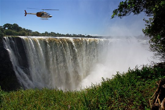 A scenic helicopter flights over the raging flood waters of the Victoria Falls.
