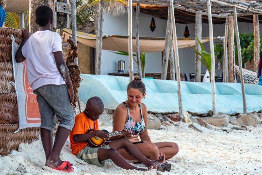 Teaching local children how to play guitar in Zanzibar.