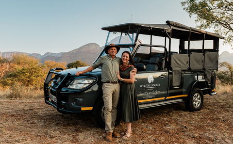 Couple standing in front of Hylton Langley Safaris Open Vehicle