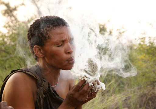 San woman from the Ghanzi district in Botswana makes a traditional fire through friction.