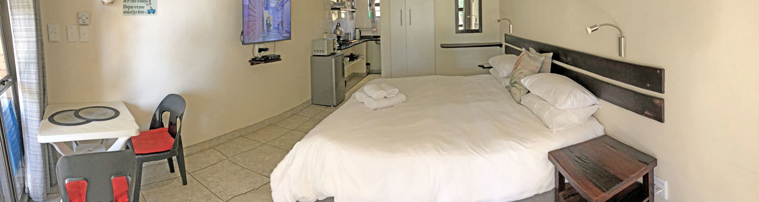 Guinea Fowl Rooms at Hills and Dales Accommodation, which comprise of a double room, patio and braai area.  Situated in the countryside close to Lanseria Airport.  The rooms feature a kitchenette, aircon and shower.  Suitable for all types of guests.