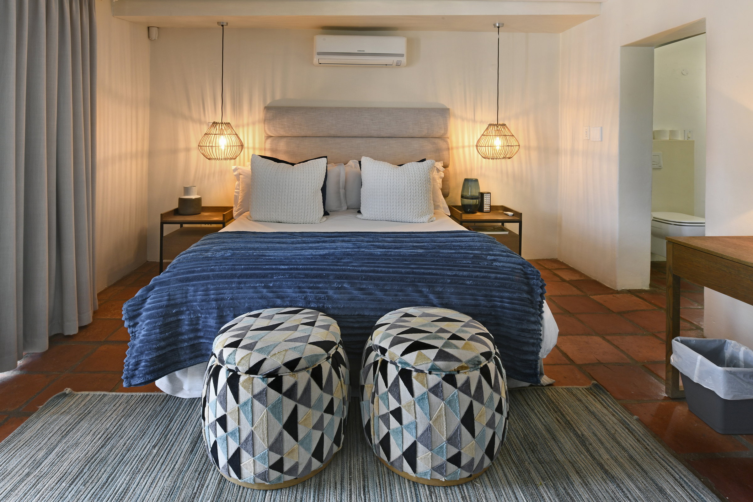 Bright bedroom with terrace overlooking the pool and garden at our boutique guesthouse in Franschhoek