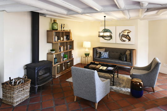 Cozy guest lounge with fireplace and book exchange in Franschhoek