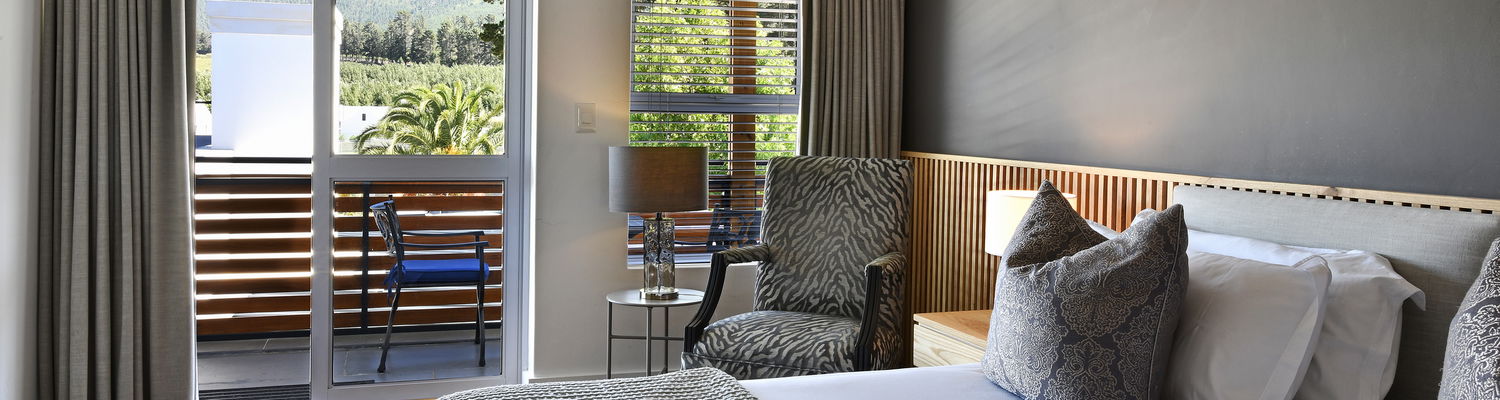 Elegant guestroom with king-size bed and ensuite bathroom at Mirabelle Guesthouse