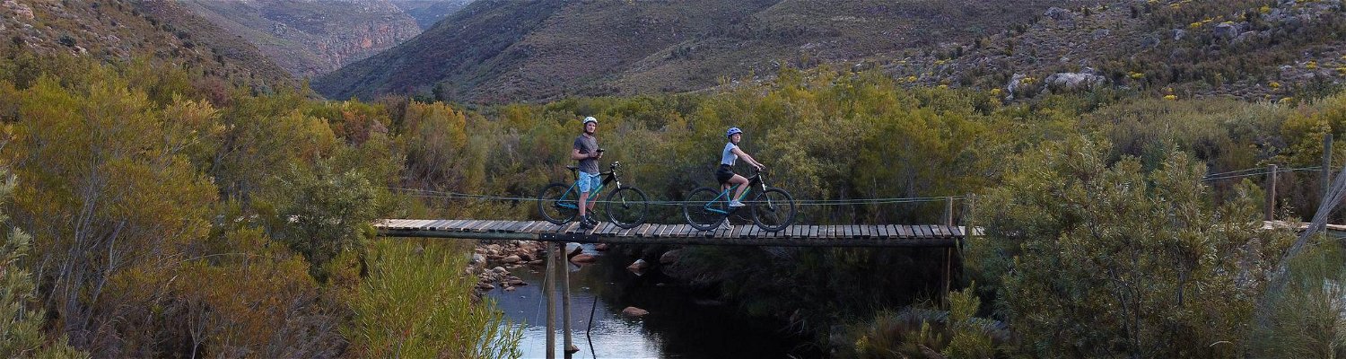 Mountain Bikers at Wolvenberg & Stille Waters campsites crossing the Waterkloof river.