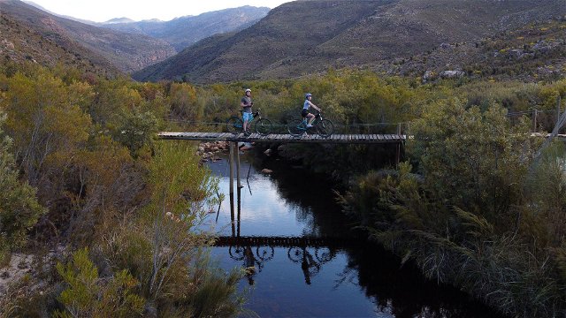 Mountain Bikers at Wolvenberg & Stille Waters campsites crossing the Waterkloof river.